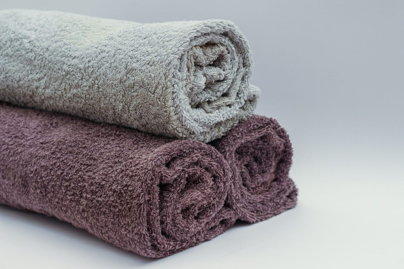 A close up of three rolled towels on top of each other