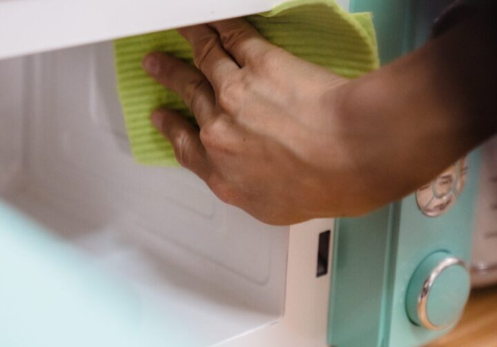 A person cleaning the inside of an oven.